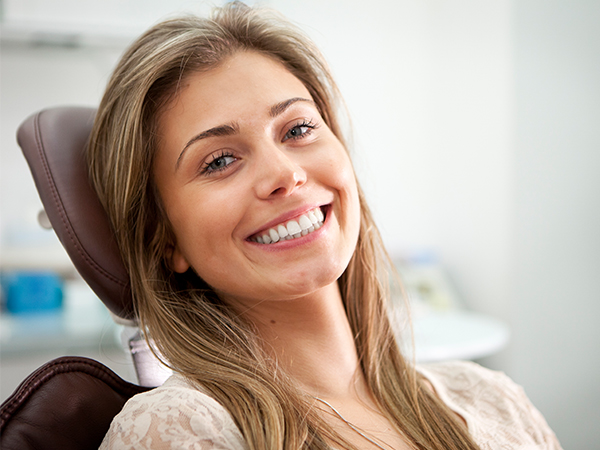 Smiling woman in dental chair at Aspire Dental office during appointment