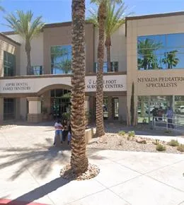 Aspire Dental storefront exterior with palm trees and modern architectural facade in shopping center.