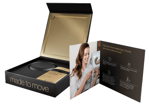 Aspire Dental branded packaging box displaying promotional materials and product samples on white background.